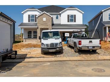 Exterior view of home under construction with a brick facade and white siding details at 667 White Birch Ln, Angier, NC 27501