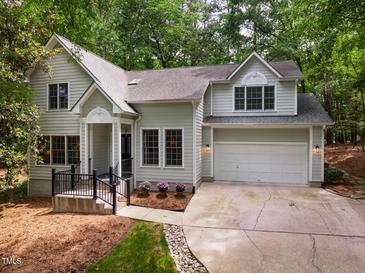 Charming two-story home with a well-manicured lawn, attached garage and a welcoming front porch at 103 Red Cedar Pl, Chapel Hill, NC 27514