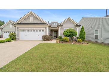 Charming single-Gathering home with a well-manicured lawn, attractive landscaping, and a two-car garage at 104 Spindle Dr, Durham, NC 27703