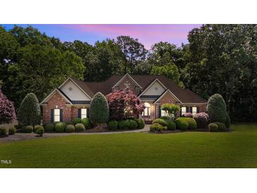 Beautiful brick home with mature landscaping and a welcoming entrance for curb appeal at 12504 Bayleaf Church Rd, Raleigh, NC 27614