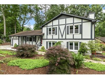 Charming two-story home with a beautifully landscaped front yard, featuring Tudor-style architecture at 1420 Seabrook Ave, Cary, NC 27511