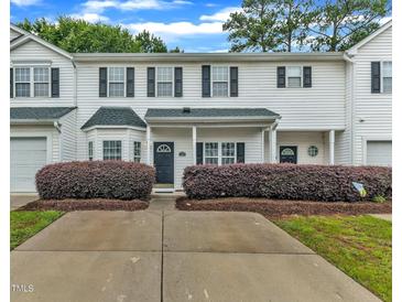 Charming townhome with a well-manicured front yard and a covered entrance, blending comfort and curb appeal at 220 Misty Groves Cir, Morrisville, NC 27560