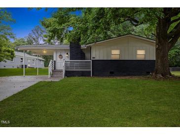 Charming home featuring a covered entrance, dark brick accents and a well maintained lawn at 2752 Weldon Ter, Durham, NC 27703