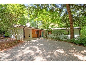 Charming single-story home featuring a gravel driveway and well maintained landscaping at 800 Shady Lawn Rd, Chapel Hill, NC 27514