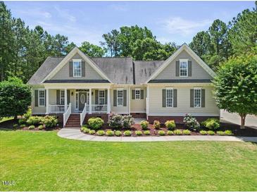 Charming home featuring a landscaped front yard, cozy porch, and neutral siding, exuding curb appeal at 113 Cedardale Ct, Clayton, NC 27520