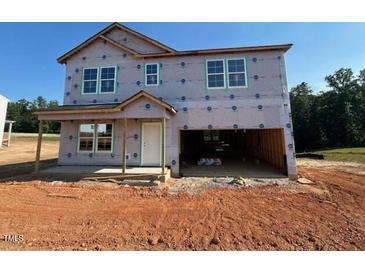 Unfinished two-story home with an attached two-car garage and a covered front porch at 135 Cordoba Dr, Franklinton, NC 27525