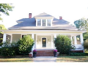 Charming home showcasing a covered porch and well-manicured landscaping at 208 Glenn St, Franklinton, NC 27525