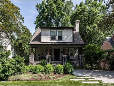 Charming two-story home with landscaped front yard and inviting covered porch with stone accents at 2303 Byrd St, Raleigh, NC 27608