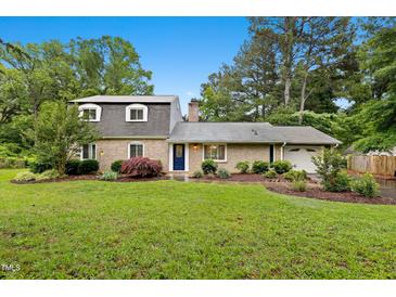 Charming two-story brick home with a well-manicured lawn and established landscaping at 2805 Friendship Rd, Durham, NC 27705