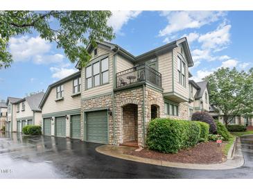 Charming townhouse with stone accents, green trim, and a private balcony, offers a sophisticated curb appeal at 301 Presque Isle Ln, Chapel Hill, NC 27514