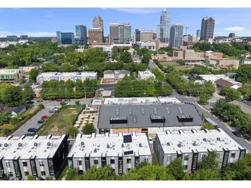 Stunning aerial view of modern townhomes in the city with a rooftop and lush greenery at 414 Chavis Way, Raleigh, NC 27601