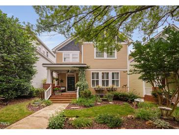 Charming two-story home featuring a welcoming front porch and beautifully landscaped front yard at 4409 All Points View Way, Raleigh, NC 27614