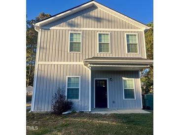 Charming two-story home featuring vertical siding, a covered porch, and neatly trimmed windows at 805 Da Vinci St, Durham, NC 27704