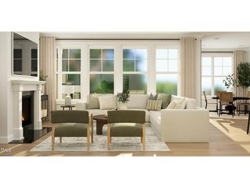 Bright living room featuring a fireplace, large windows, and comfortable seating arrangement at 945 Cassa Clubhouse Way, Knightdale, NC 27545