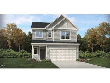 Charming two-story home with gray siding, a two-car garage, and a landscaped front yard at 100 Fishing Pier Way, Lillington, NC 27546