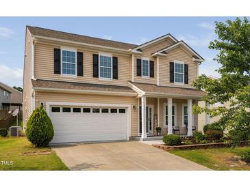 Charming two-story home features a welcoming front porch and a two-car garage at 105 Putters Ct, Durham, NC 27703