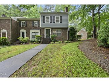 Charming townhome with manicured lawn, brick facade, and inviting entryway at 1200 Collington Dr, Cary, NC 27511