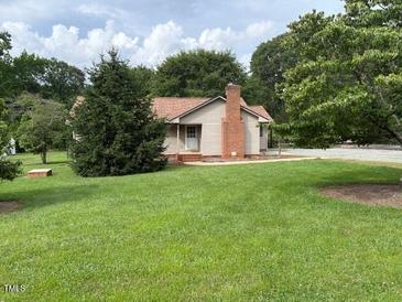 Charming single-story home with a brick chimney and a well-maintained lawn at 1942 Brier Ln, Graham, NC 27253