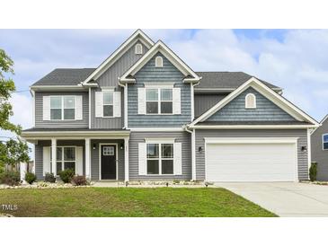 Charming two-story home with gray siding, white trim, and a well-manicured lawn, showing great curb appeal at 225 Rosewood Ln, Youngsville, NC 27596