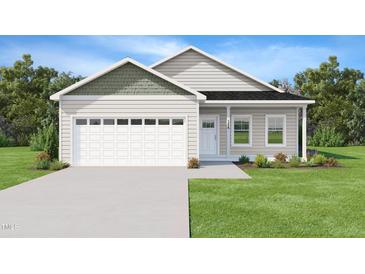 Charming single-story home with a two-car garage, manicured lawn, and inviting front entrance at 2819 Ricolden Trl, Elon, NC 27244