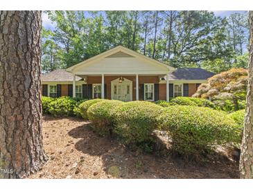 Charming brick home with manicured landscaping and a welcoming front porch at 3911 Hope Valley Rd, Durham, NC 27707