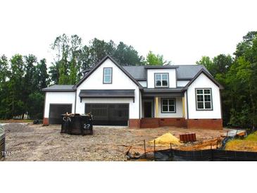 Beautiful craftsman-style home with a mix of white siding, brick and natural accents at 5900 Tranquil Cv, Youngsville, NC 27596