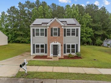 Charming two-story home with solar panels, well-maintained lawn, and inviting curb appeal at 612 Quartz Dr, Durham, NC 27703