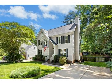 Charming two-story home featuring a well-manicured lawn, neutral siding and black shutters under a sunny sky at 6912 Baywood Dr, Raleigh, NC 27613
