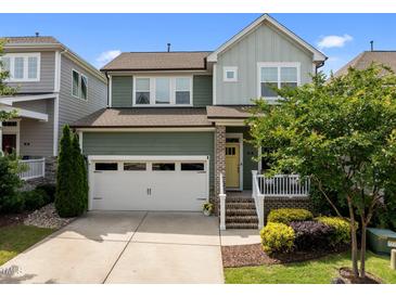 Charming two-story home with a white two car garage, a porch, and manicured landscaping at 78 Salt Cedar Ln, Chapel Hill, NC 27516