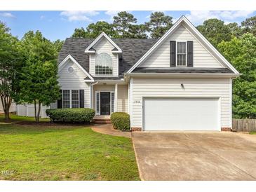 Charming home with a two-car garage, manicured lawn, and classic architectural details at 7936 Milltrace, Raleigh, NC 27615