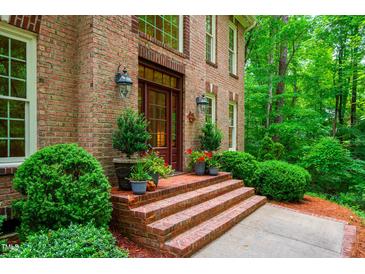 Charming brick home with a welcoming front entrance and landscaped garden at 101 Collinson Dr, Chapel Hill, NC 27514