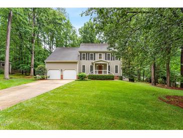 Traditional two-story home with a well-manicured lawn, mature trees, and a two-car garage at 106 Ridgepath Way, Cary, NC 27511