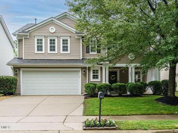 Charming two-story home with a well-manicured lawn, a two car garage, and appealing curb appeal at 1833 Creek Oak Circle Cir, Fuquay Varina, NC 27526
