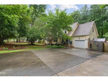 Charming home with a two-car garage and long driveway surrounded by lush trees at 275 Eagle Stone Rdg, Youngsville, NC 27596