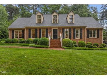 Charming brick home featuring a well-manicured lawn and dormer windows at 3919 Wentworth Dr, Durham, NC 27707