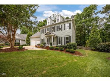 Charming two-story home with manicured lawn and lush landscaping creates a welcoming curb appeal at 106 Fawley Ct, Cary, NC 27519