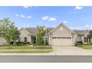 Charming single-story home with a two-car garage, manicured lawn, and mature trees at 118 Manning Way, Durham, NC 27703