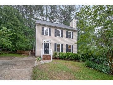 Traditional two-story home featuring a well-manicured lawn, black shutters and a welcoming front entrance at 12 Striding Ridge Ct, Durham, NC 27713