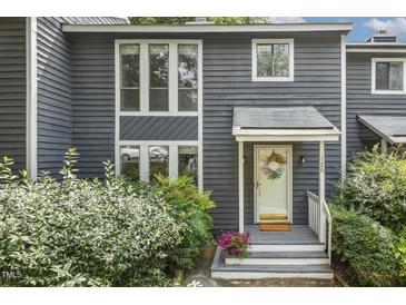 Charming two-story home with blue siding, well-maintained landscaping, and inviting front porch at 120 Jo Anne Cir, Cary, NC 27513