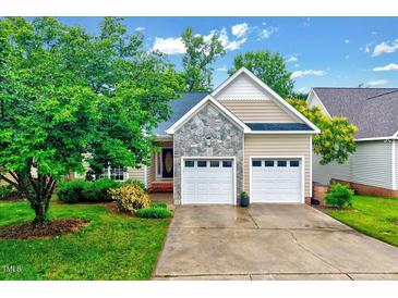 Charming single-story home with stone accents, well-manicured lawn, and a two-car garage at 1216 Miracle Dr, Wake Forest, NC 27587