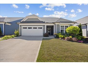 Charming single-story home featuring a two-car garage, well-maintained lawn and colorful landscaping at 1533 Santa Lucia St, Wake Forest, NC 27587