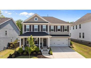 Charming two-story home with a welcoming front porch and attached two-car garage at 2012 Sweet Samson St, Wake Forest, NC 27587