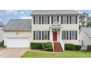 Two-story home featuring classic black shutters, a red front door, and a well-maintained lawn at 2301 Laurel Valley Way, Raleigh, NC 27604