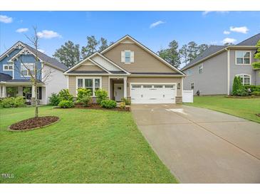 Charming single-Gathering home with a two-car garage and a well-manicured front lawn at 247 Axis Deer Ln, Garner, NC 27529