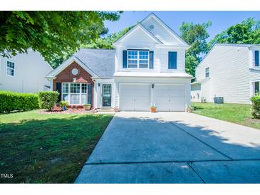 Charming two-story home featuring a well-manicured lawn and a two-car garage at 3016 Hayling Dr, Raleigh, NC 27610
