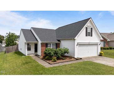 Charming single Gathering home featuring classic white siding, a brick accent, and well maintained landscaping at 4408 Jordan Oaks Way, Raleigh, NC 27604