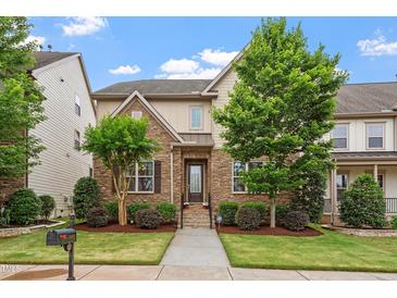 Charming two-story home with a stone facade, landscaped yard, and a welcoming entrance at 5003 Blue Jack Oak Dr, Cary, NC 27519