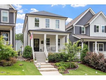 Charming two-story home featuring a welcoming front porch, landscaped yard, and inviting curb appeal at 586 Great Ridge Pkwy, Chapel Hill, NC 27517