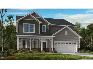 Charming two-story home featuring a covered porch and a two-car garage at 618 Contento Ct, Sanford, NC 27330