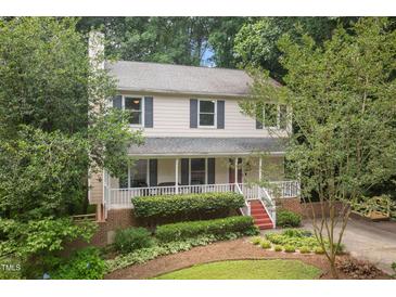 Charming two-story home with a welcoming front porch and beautifully landscaped front yard at 905 Balmoral Dr, Cary, NC 27511